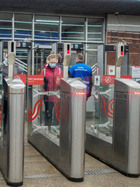 Yolcular Moskova metro istasyonundaki otomatik turnikelerden geçiyorlar.. 