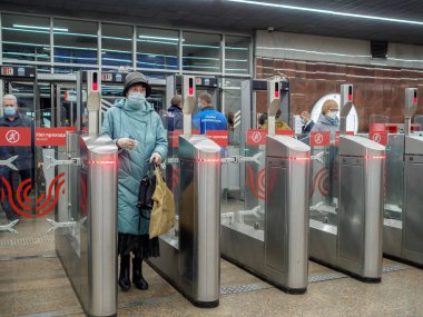 Yolcular Moskova metro istasyonundaki otomatik turnikelerden geçiyorlar.. 