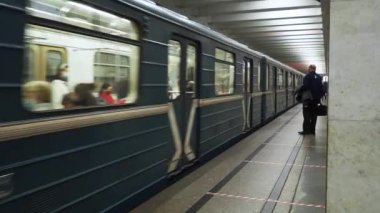 Koruyucu maskeler takan yolcular metro vagonlarından inip iniyorlar..