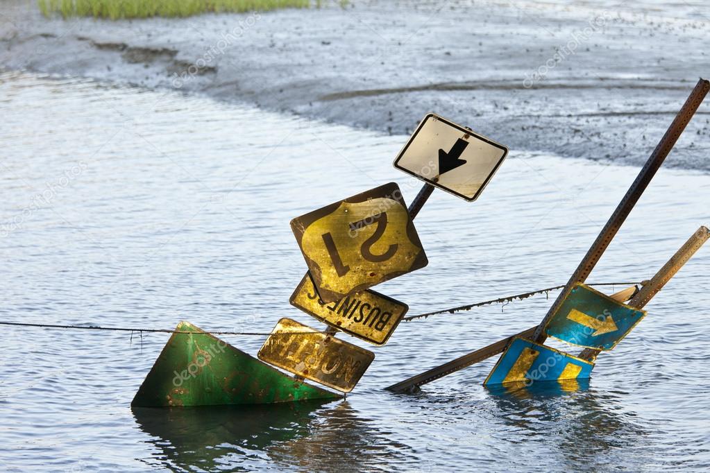 highway signs on flooded road