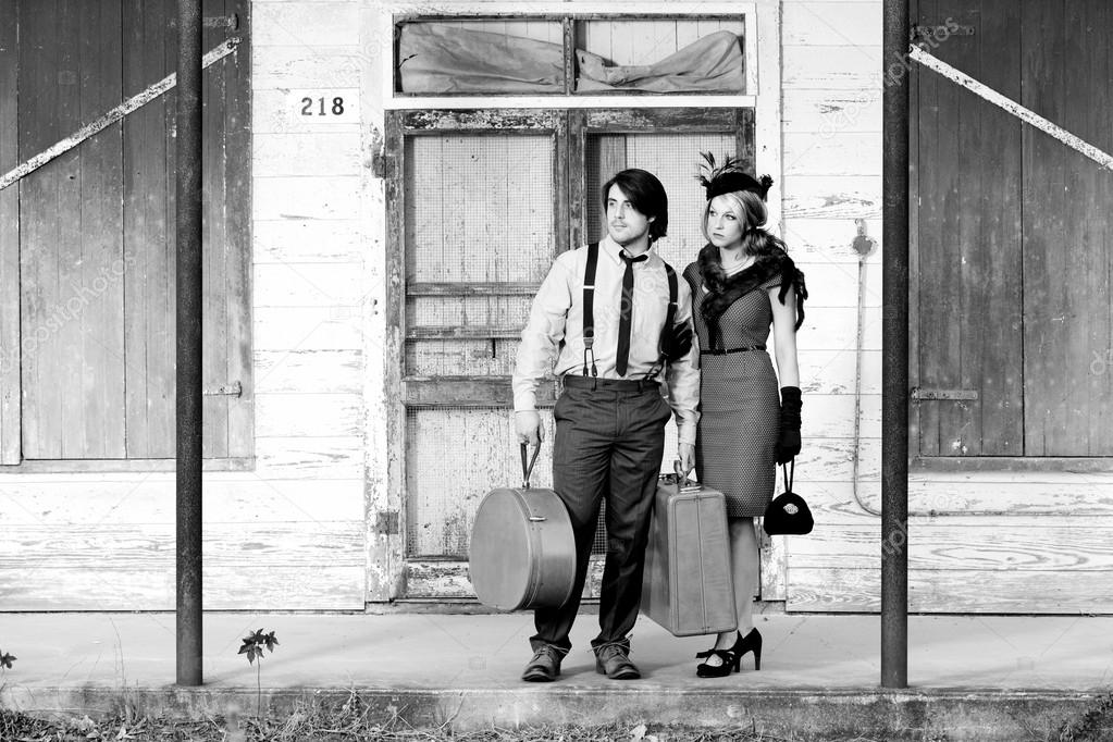 Couple waiting for bus, 1940s clothing