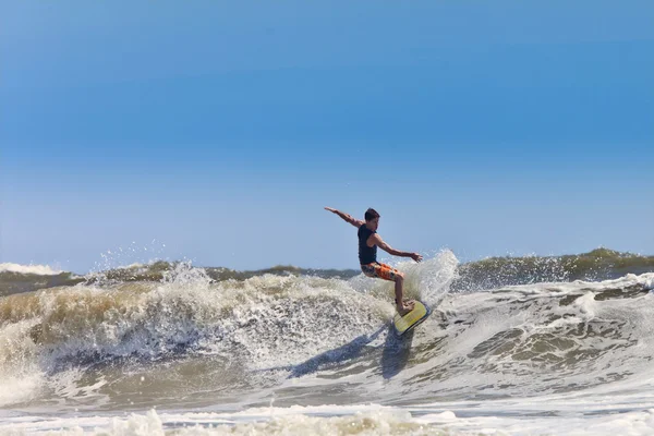 surfer catching waves