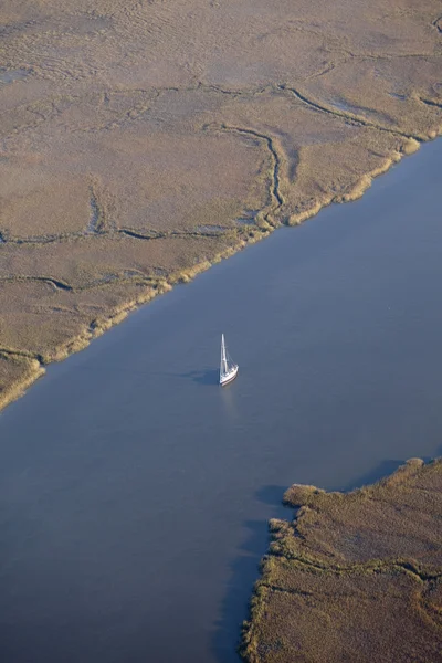 Sailboat on meandering river — Stock Photo, Image