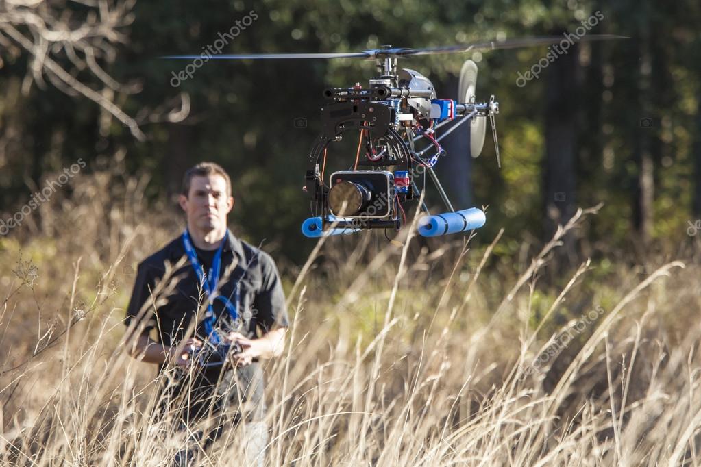 Man flying uav helicopter — Stock Photo © Wollwerth #78779810