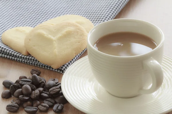 Coffee cup with grains and cookie. — Stock Photo, Image