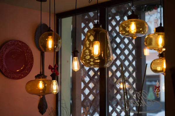 Yellow lamps hang from the ceiling in the cafe — Stock Photo, Image