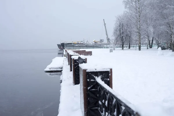 Dark Onega Lake in winter, covered with white ice