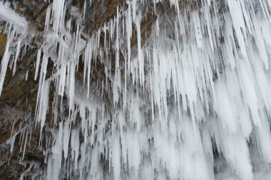 Buz ve kar kalıpları ve buz sarkıtları kayaların üzerinde ve kışın bir mağarada