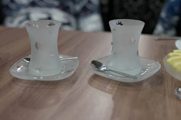 Tasses en verre transparent sur une soucoupe avec une cuillère — Photo