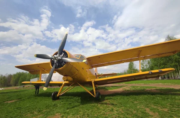 Yellow plane on a background of sky and grass — Stock Photo, Image