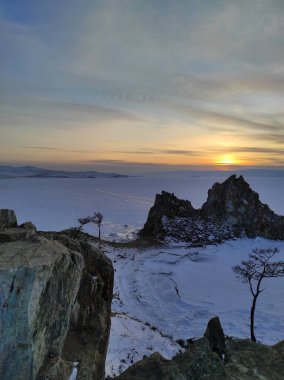 Gün batımında dağlı karlı göl