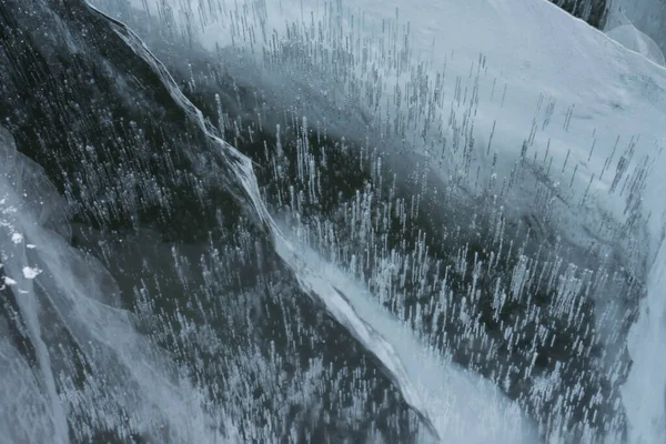 Cracks in transparent ice on a lake in winter — Stock Photo, Image