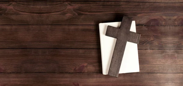 Closed books holy bible. Scripture. Cross of Jesus. On a wooden background