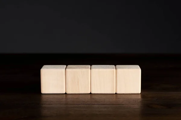 Деревянные Кубики Столе Черном Фоне Четыре — стоковое фото