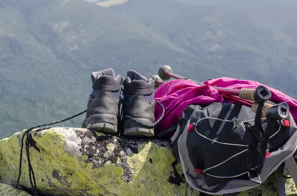 Trekking shoes sneakers. Hiking backpack. Against the background of the mountains. Hiking in the mountains.