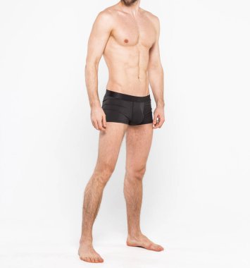 Beyaz arka planda izole edilmiş iç çamaşırı giyen kaslı genç bir adam. Erkekler için iç çamaşırı kopyalama alanı