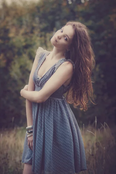 Mooie vrouw blu jurk buiten in veld — Stockfoto