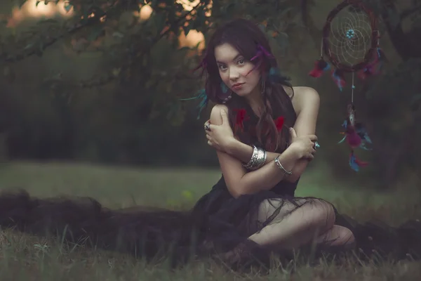 Portrait of a beautiful woman with feather  in her hair. Boho fa — Stock Photo, Image