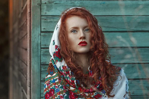 Beautiful Redhead  young woman  in the  national head scarf, rel — Stock Photo, Image