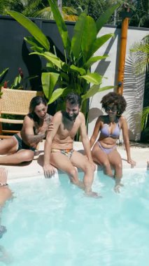 Genç bir kadın, yaz partisinde sakallı erkek arkadaşını neşeyle havuza itiyor. Çeşitli arkadaşlar güler ve anın tadını çıkarırlar. Dikey