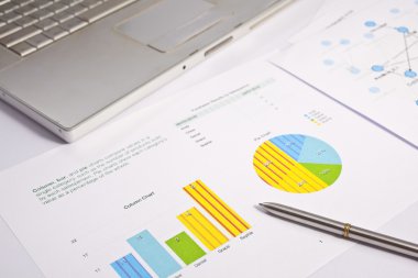 Financial charts and graphs on the table clipart