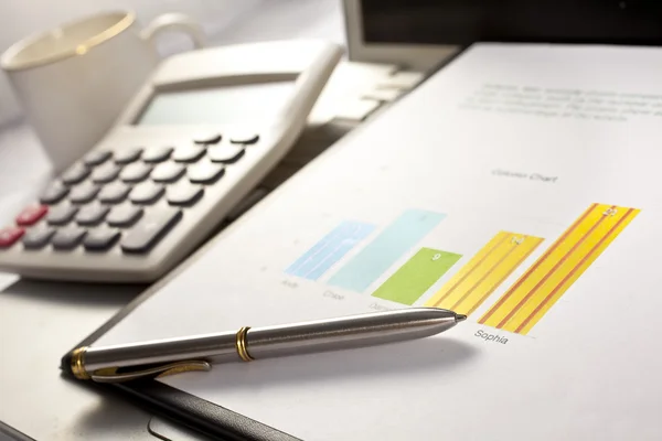 Businessman working on the calculator and his laptop — Stock Photo, Image