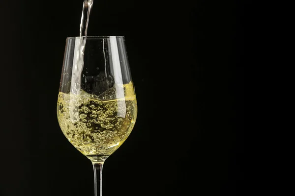 White wine pouring in a glass — Stock Photo, Image