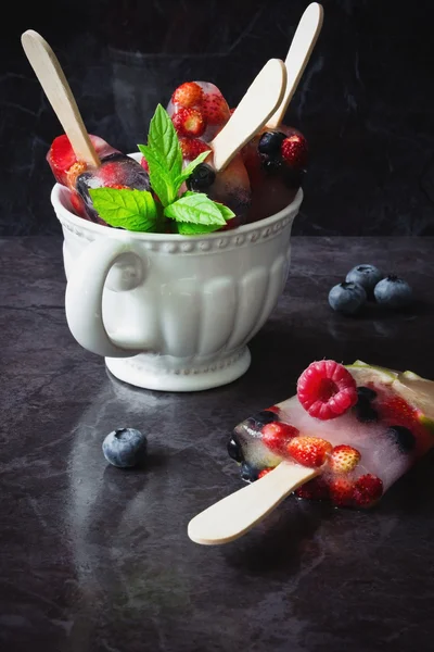 Frozen berries on a stick — Stock Photo, Image