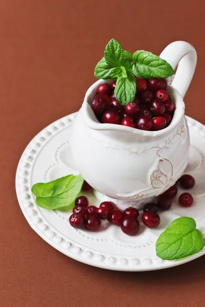 Cranberries in a small vintage jug — Stock Photo, Image