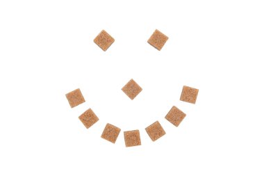 Beyaz arkaplanda şeker küplerinden yapılmış bir gülümseme. 