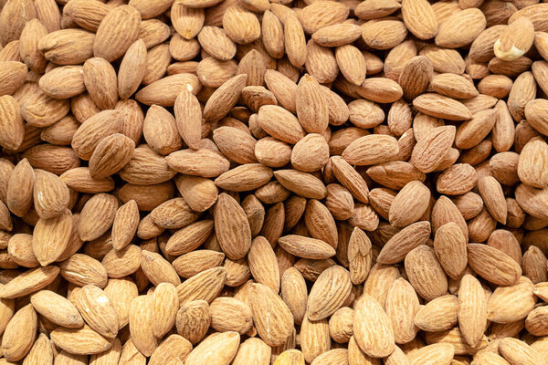 almonds plant dry seeds texture pattern background. Top view blur textures soft focus.