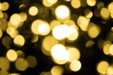Bir sürü çözülmüş Bokeh noel arkaplanda büyük altın ışıklar. Bulanık altın parıltısı dokusu. Noel, yeni yıl ya da festival arka planı için altın parlayan duvar kağıdı.