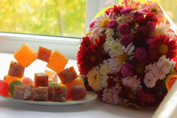 Autumn flowers and sweets — Stock Photo, Image