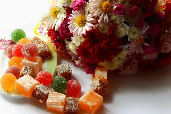 Autumn flowers and sweets — Stock Photo, Image