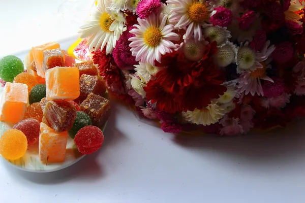 Autumn flowers and sweets — Stock Photo, Image