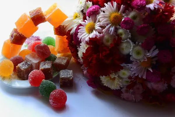 Autumn flowers and sweets — Stock Photo, Image