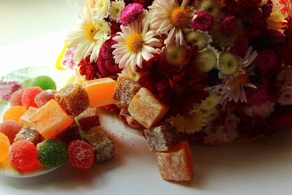 Autumn flowers and sweets — Stock Photo, Image