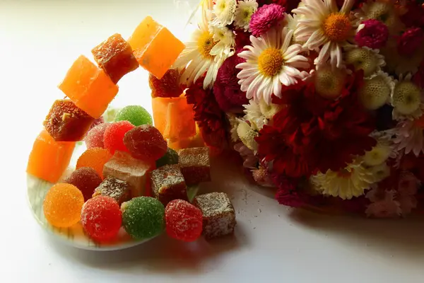 Autumn flowers and sweets — Stock Photo, Image