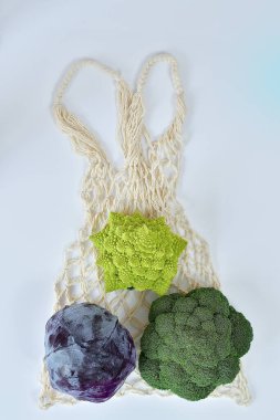 Farklı türde lahanalarla dolu bir tekstil çantası. Sıfır atık yiyecek alışverişi. Beyaz arka planda eko doğal torbalar. Çevre dostu kavram. Plastiksiz minimalist yaşam tarzı. Yeniden kullan, azalt, geri dönüştür..