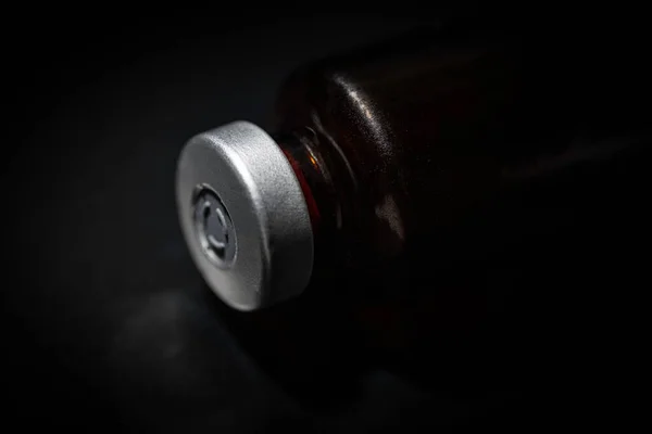Makro Ujęcie Wybiórczym Ukierunkowaniem Butelkę Zawierającą Szczepionkę Koloru Bursztynowego Umieszczoną — Zdjęcie stockowe