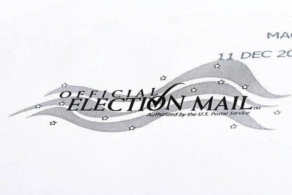 Vidalia, Georgia / USA - December 16, 2020: An illustrative macro shot of the official United States election mail logo print on the front of a white mailing envelope.