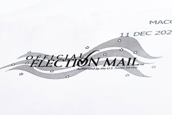 Vidalia, Georgia / USA - December 16, 2020: An illustrative macro shot of the official United States election mail logo print on the front of a white mailing envelope.