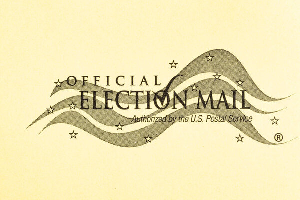 Vidalia, Georgia, USA - December 16, 2020 - An illustrative macro shot of the official United States election mail logo print on the front cover of a yellow mailing envelope.