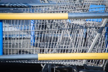 A close-up shot of a shopping cart at the parking lot of a grocery store. clipart