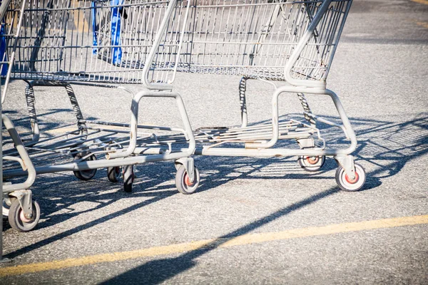 A close-up shot of a shopping cart at the parking lot of a grocery store.