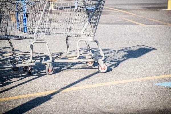 A close-up shot of a shopping cart at the parking lot of a grocery store.