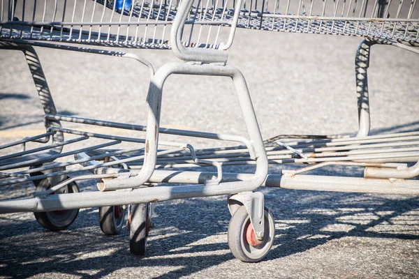 A close-up shot of a shopping cart at the parking lot of a grocery store.