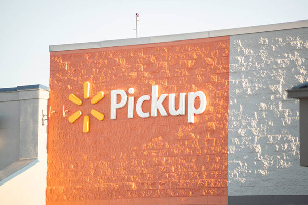 Vidalia, Georgia, USA - May 6, 2021: The signage of Walmarts Pick-Up service on a section of their storefront.