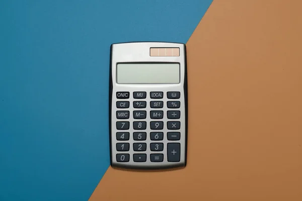 electronic digital calculator on geometric colored background