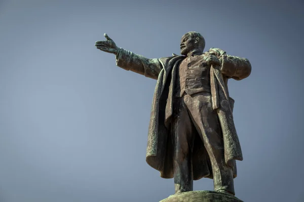 The leader of the world proletariat, Vladimir Ilyich Lenin. Monument in the city of St. Petersburg. A sculpture of a man with an outstretched hand against a blue sky. Spring day.